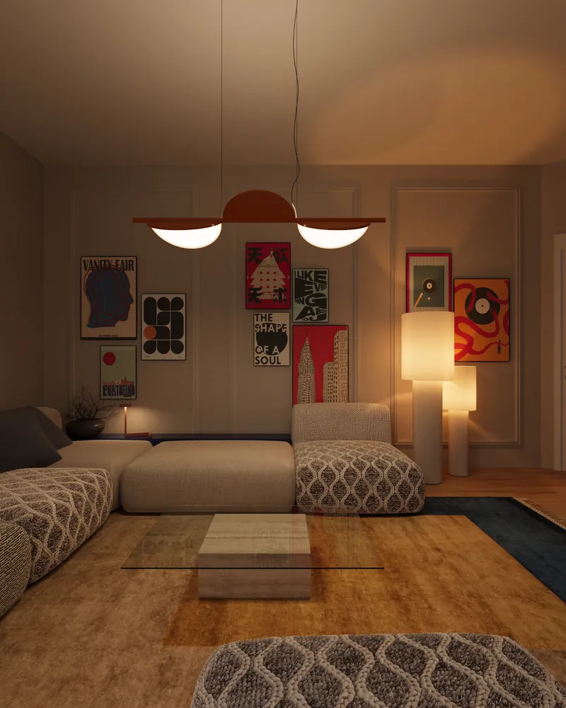 LM Apartment at night: a low sofa, a pendant light and a wall of framed posters in warm lamplight.